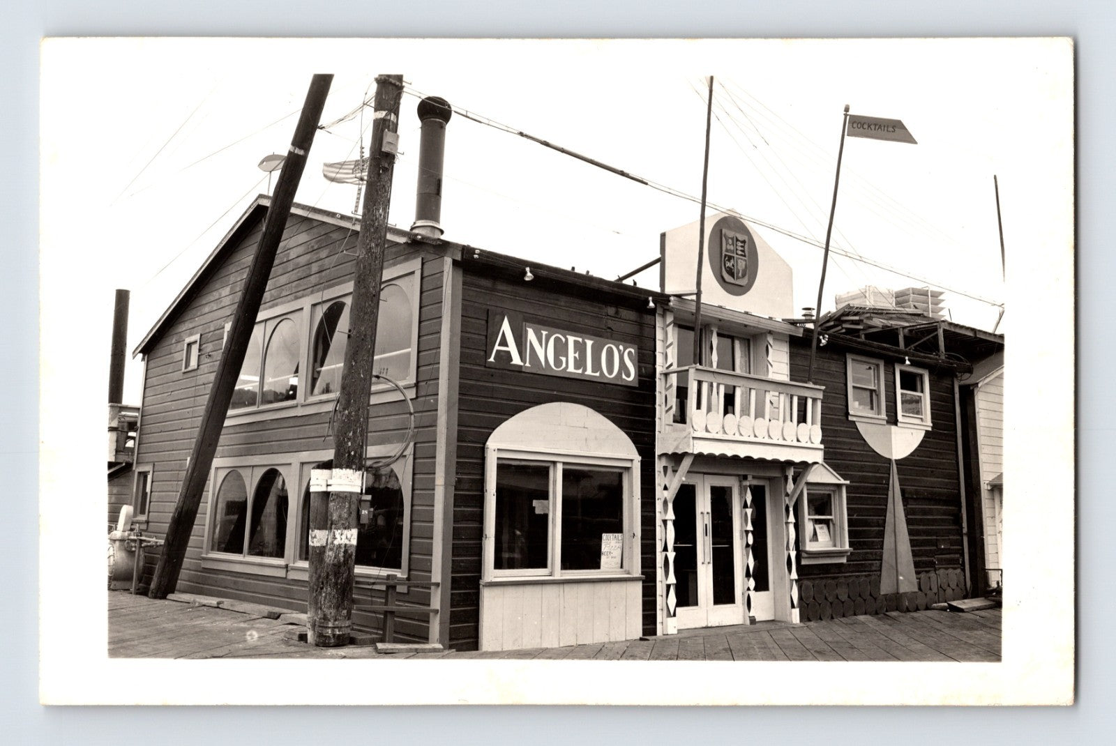 Monterey California Angelo’s Wharf restaurant RPPC postcard with waterfront building and handwritten 1946 dining note