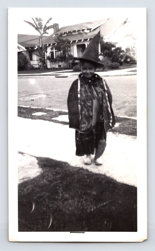 Halloween child witch costume sidewalk suburban house palm tree 1950s snapshot