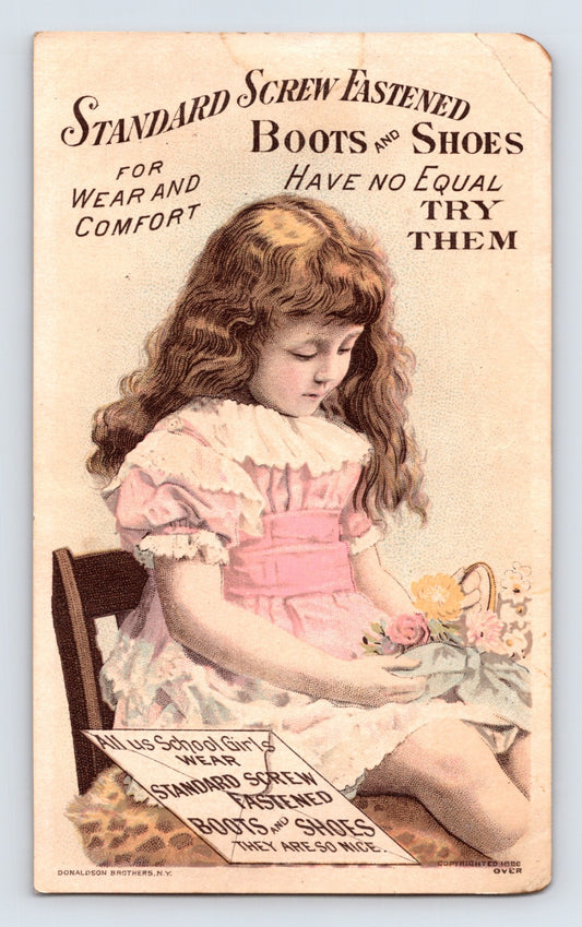 Lester Boot Victorian trade card with girl holding flowers, Binghamton New York shoe advertising card, 5.5 x 3.5