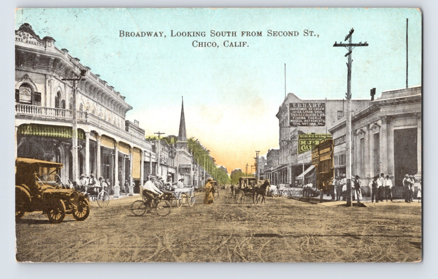 Chico California Broadway looking south from Second Street postcard showing dirt roadway, horse-drawn carriages, storefronts, pedestrians, utility poles, and early downtown commercial buildings.