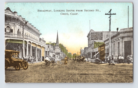 Chico California Broadway looking south from Second Street postcard showing dirt roadway, horse-drawn carriages, storefronts, pedestrians, utility poles, and early downtown commercial buildings.